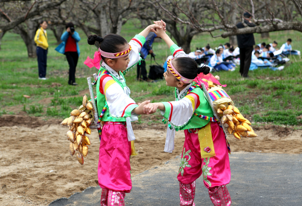 Children Dancing in Colorful Traditional Costumes 