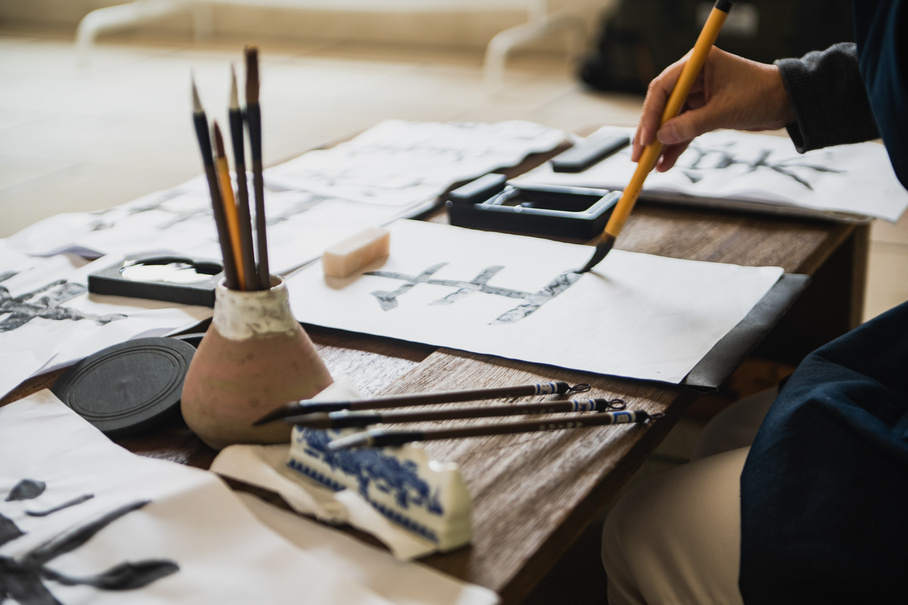 Person Writing Japanese Calligraphy 