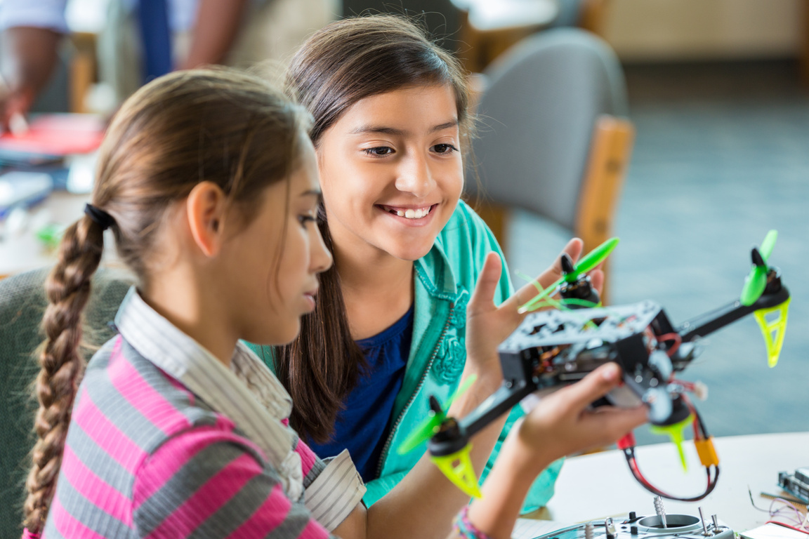 Elementary girls using drones during after school science program